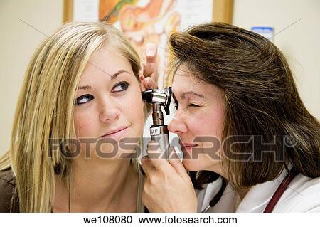 A doctor examining a teenage female patient with an ear scope View Large Photo Image Stock Image - A doctor examining a teenage female patient with an ear scope. Fotosearch