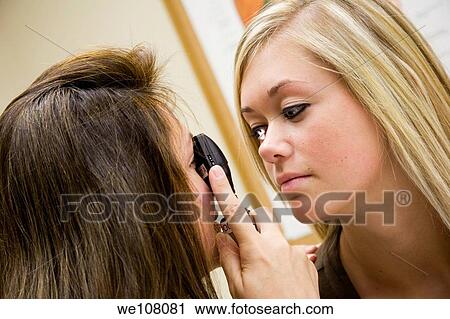A doctor examining a teenage female patient with an eye scope View Large Photo Image Stock Image - A doctor examining a teenage female patient with an eye scope. Fotosearch