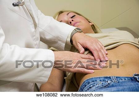 A doctor examining a teenage female patient View Large Photo Image Stock Image - A doctor examining a teenage female patient. Fotosearch
