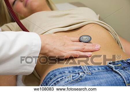 A doctor examining a teenage female patient View Large Photo Image Stock Image - A doctor examining a teenage female patient. Fotosearch