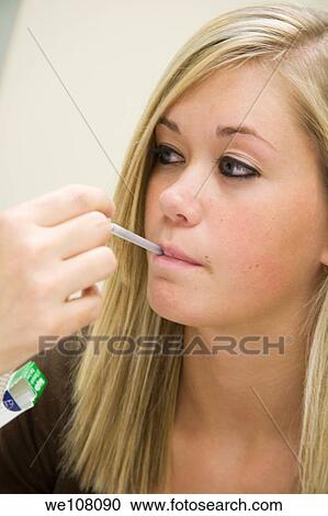 A doctor examining a teenage female patient Having her temperature taken View Large Photo Image Stock Image - A doctor examining a teenage female patient Having her temperature taken. Fotosearch