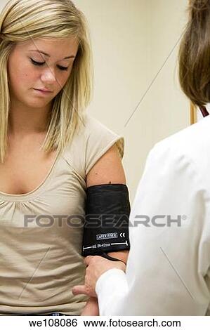 A doctor examining a teenage female patient Having her blood pressure checked View Large Photo Image Stock Photograph - A doctor examining a teenage female patient Having her blood pressure checked. Fotosearch
