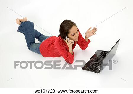 African American teen working on laptop computer and talking ona cell phone View Large Photo Image Stock Image - African American teen working on laptop computer and talking ona cell phone. Fotosearch