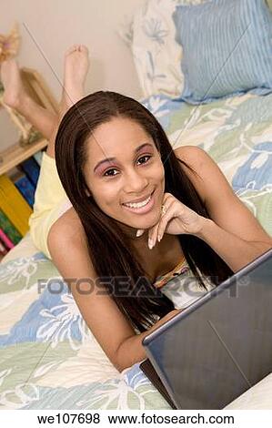 African American teen working on laptop computer View Large Photo Image Stock Photo - African American teen working on laptop computer. Fotosearch