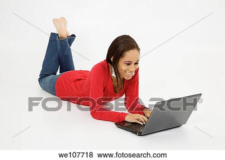 African American teen working on laptop computer View Large Photo Image Stock Photo - African American teen working on laptop computer. Fotosearch