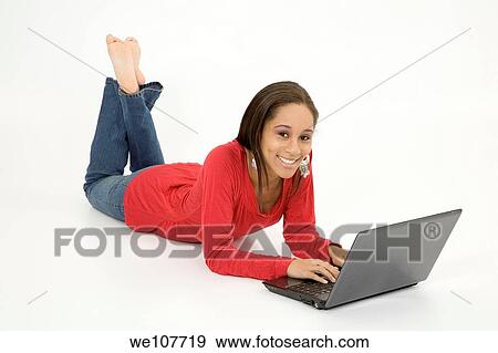 African American teen working on laptop computer View Large Photo Image Stock Photo - African American teen working on laptop computer. Fotosearch