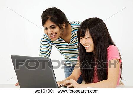 Asian and East Indian teenagers looking surprised by what they found on the laptop computer View Large Photo Image Stock Image - Asian and East Indian teenagers looking surprised by what they found on the laptop computer. Fotosearch