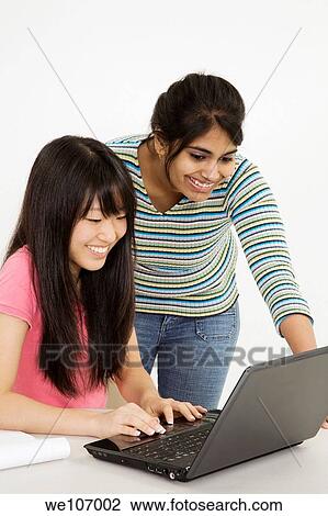 Asian and East Indian teenagers working on a the laptop computer View Large Photo Image Stock Image - Asian and East Indian teenagers working on a the laptop computer. Fotosearch