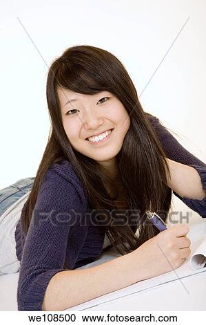Asian teenager working on homework View Large Photo Image Stock Image - Asian teenager working on homework. Fotosearch