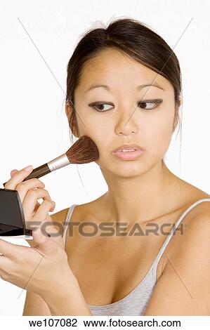 Asian woman applying facial power View Large Photo Image Stock Image - Asian woman applying facial power. Fotosearch