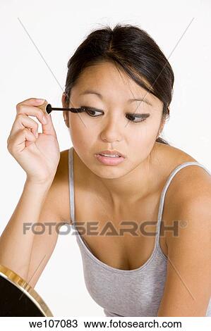 Asian woman applying mascara View Large Photo Image Stock Image - Asian woman applying mascara. Fotosearch