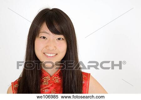 Beautiful Asian teenager in traditional dress on blue background View Large Photo Image Stock Photography - Beautiful Asian teenager in traditional dress on blue background. Fotosearch