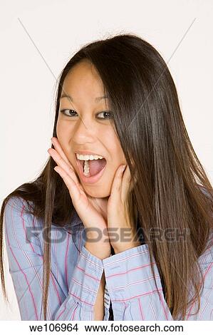 Beautiful Asian woman posing with some attitude on a white background View Large Photo Image Picture - Beautiful Asian woman posing with some attitude on a white background. Fotosearch