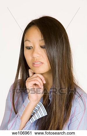 Beautiful Asian woman posing with some attitude on a white background View Large Photo Image Stock Image - Beautiful Asian woman posing with some attitude on a white background. Fotosearch
