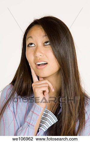 Beautiful Asian woman posing with some attitude on a white background View Large Photo Image Stock Image - Beautiful Asian woman posing with some attitude on a white background. Fotosearch