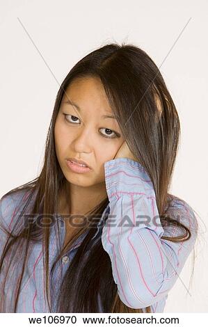 Beautiful Asian woman posing with some attitude on a white background View Large Photo Image Stock Image - Beautiful Asian woman posing with some attitude on a white background. Fotosearch