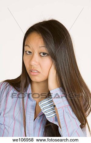 Beautiful Asian woman posing with some attitude on a white background View Large Photo Image Stock Photo - Beautiful Asian woman posing with some attitude on a white background. Fotosearch