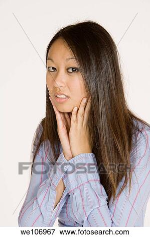 Beautiful Asian woman posing with some attitude on a white background View Large Photo Image Stock Photo - Beautiful Asian woman posing with some attitude on a white background. Fotosearch