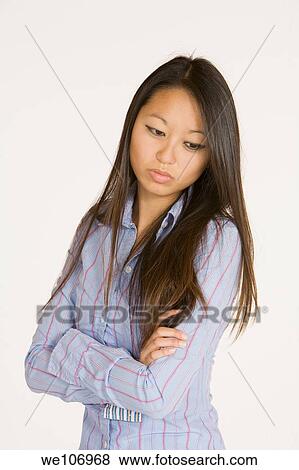 Beautiful Asian woman posing with some attitude on a white background View Large Photo Image Stock Photo - Beautiful Asian woman posing with some attitude on a white background. Fotosearch