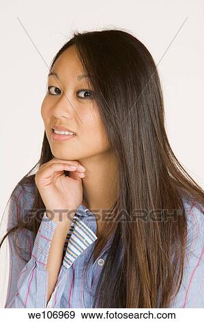Beautiful Asian woman posing with some attitude on a white background View Large Photo Image Stock Photo - Beautiful Asian woman posing with some attitude on a white background. Fotosearch