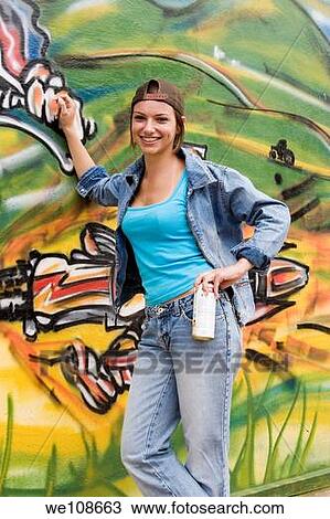 Beautiful Brazilian girl spray painting a mural on the side of a building View Large Photo Image Stock Image - Beautiful Brazilian girl spray painting a mural on the side of a building. Fotosearch
