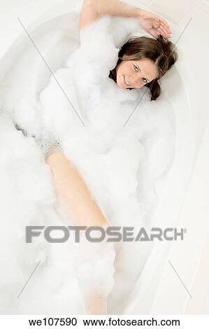Stock Image - Beautiful Caucasian Woman taking a bath. Fotosearch