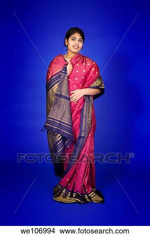 Beautiful Hindu teenager dressed in a traditional Sari dress View Large Photo Image Picture - Beautiful Hindu teenager dressed in a traditional Sari dress. Fotosearch