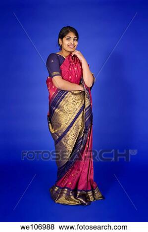 Beautiful Hindu teenager dressed in a traditional Sari dress View Large Photo Image Stock Photo - Beautiful Hindu teenager dressed in a traditional Sari dress. Fotosearch