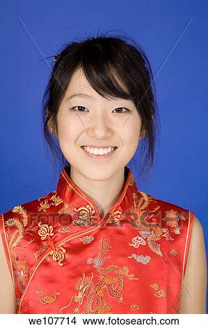 Picture - Beautiful young Asian girl posing for a portrait wearing a China Dress. Fotosearch