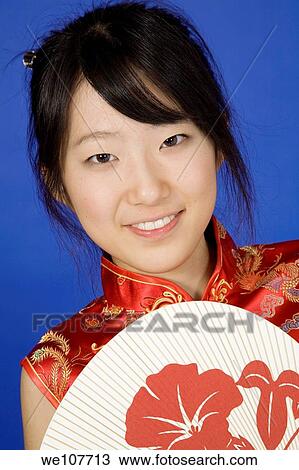 Beautiful young Asian girl posing for a portrait wearing a China Dress View Large Photo Image Stock Image - Beautiful young Asian girl posing for a portrait wearing a China Dress. Fotosearch