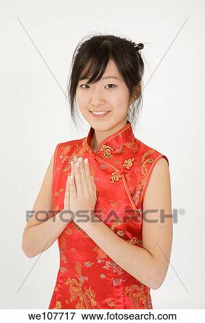 Beautiful young Asian girl posing for a portrait wearing a China Dress View Large Photo Image Stock Photo - Beautiful young Asian girl posing for a portrait wearing a China Dress. Fotosearch