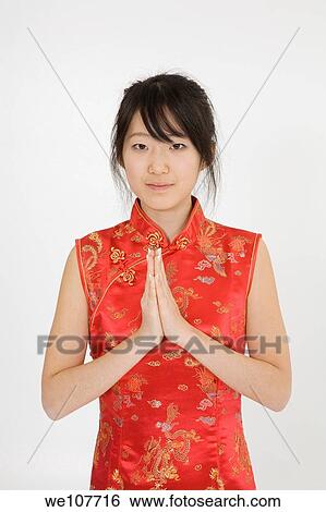 Beautiful young Asian girl posing for a portrait wearing a China Dress View Large Photo Image Stock Photograph - Beautiful young Asian girl posing for a portrait wearing a China Dress. Fotosearch