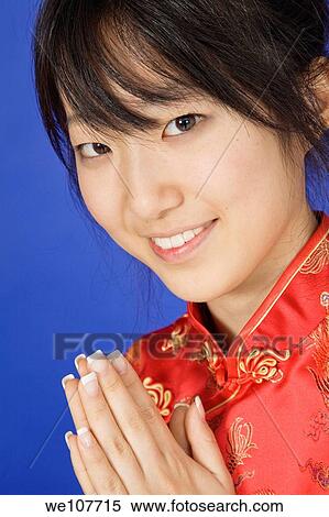 Beautiful young Asian girl posing for a portrait wearing a China Dress View Large Photo Image Stock Photography - Beautiful young Asian girl posing for a portrait wearing a China Dress. Fotosearch