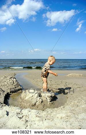 Boy playing on a Baltic Sea beach in Jantar village, Poland View Large Photo Image Stock Image - Boy playing on a Baltic Sea beach in Jantar village, Poland. Fotosearch