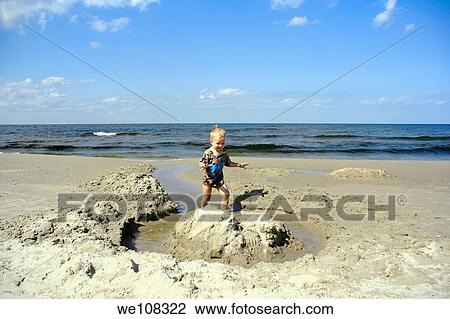 Boy playing on a Baltic Sea beach in Jantar village, Poland View Large Photo Image Stock Image - Boy playing on a Baltic Sea beach in Jantar village, Poland. Fotosearch