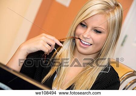 Picture - Businesswoman in early 20s working on a computer. Fotosearch