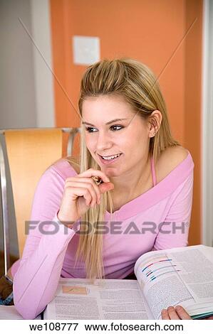 Caucasian college student working on home work View Large Photo Image Stock Photo - Caucasian college student working on home work. Fotosearch
