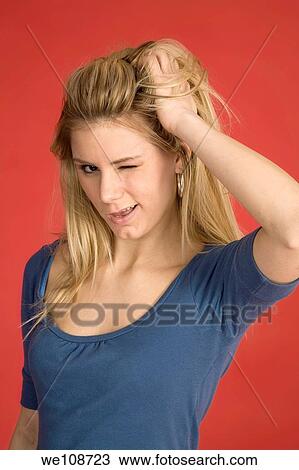 Stock Image - Caucasian woman showing facial expressions in a studio. Fotosearch
