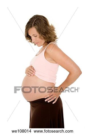 Picture - Caucasian woman who is 9 months pregnant on white background. Fotosearch