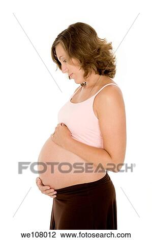 Caucasian woman who is 9 months pregnant on white background View Large Photo Image Stock Image - Caucasian woman who is 9 months pregnant on white background. Fotosearch