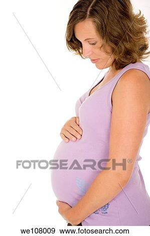Caucasian woman who is 9 months pregnant on white background View Large Photo Image Stock Photo - Caucasian woman who is 9 months pregnant on white background. Fotosearch