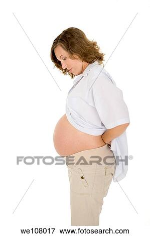 Stock Photo - Caucasian woman who is 9 months pregnant on white background. Fotosearch