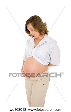 Caucasian woman who is 9 months pregnant on white background View Large Photo Image Stock Photo - Caucasian woman who is 9 months pregnant on white background. Fotosearch
