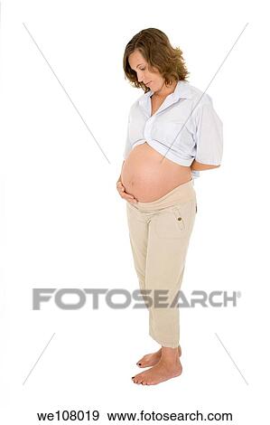 Stock Photo - Caucasian woman who is 9 months pregnant on white background. Fotosearch