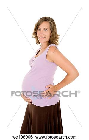 Stock Photograph - Caucasian woman who is 9 months pregnant on white background. Fotosearch