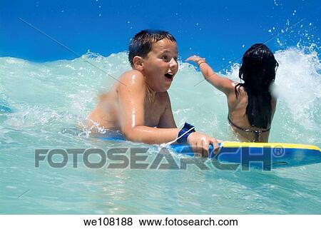 Children body boarding at surf beach, France View Large Photo Image Stock Photo - Children body boarding at surf beach, France. Fotosearch
