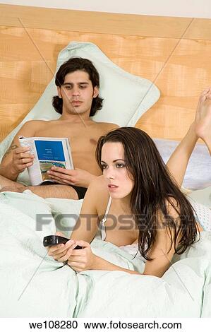 Couple watching television View Large Photo Image Stock Image - Couple watching television. Fotosearch