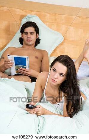 Couple watching television View Large Photo Image Stock Photo - Couple watching television. Fotosearch