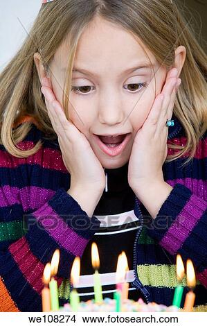 Picture - Eight year old girl having a birthday party. Fotosearch