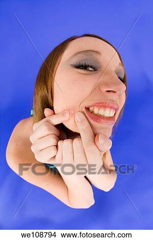Female suffering with acme on her face View Large Photo Image Picture - Female suffering with acme on her face. Fotosearch